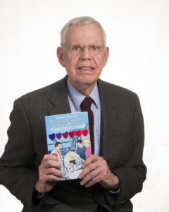 Picture of Dorrance author Armando Perez holding his book, "Mending Children's Broken Hearts."