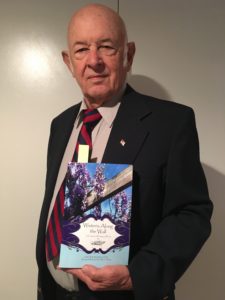 Dorrance author, Dave Forsberg holding his book, "Wisteria on the Wall."