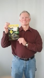 Dorrance author James Traynor holding his book.