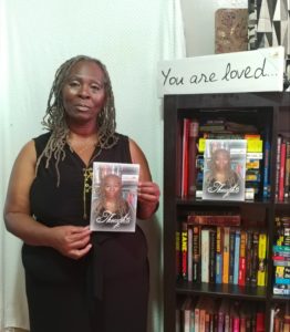 Dorrance author, Mattie Gaskins holding her book.