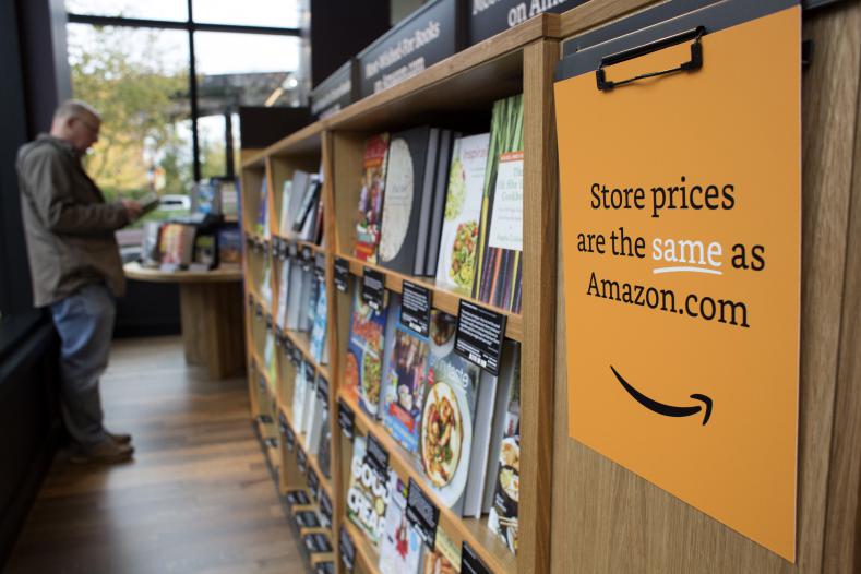 A customer shops at Amazon Books in Seattle, Washington, on Tuesday, Nov. 3, 2015. The online retailer Amazon.com Inc. opened its first brick-and-mortar location in Seattle's upscale University Village mall. Photographer: David Ryder/Bloomberg