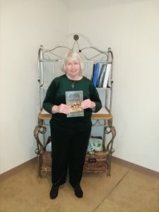 RoseDog author Amanda L. Dalton holding her book.