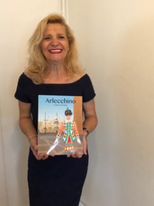 Picture of Dorrance author Grace Germana holding her book, "Arlecchino."