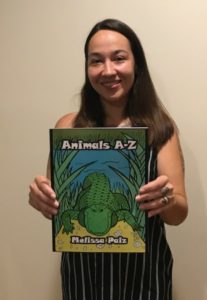 Picture of Dorrance author, Melissa Paiz, holding her book, "Animals A-Z."