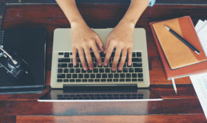 woman typing on computer