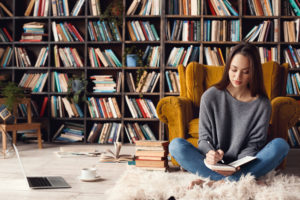 woman writing in library