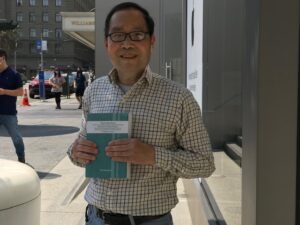 Chiu Yong Poon_Dorrance Publishing author holding his book, "The Guide Book."