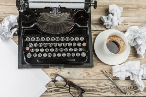 typewriter with crumpled drafts